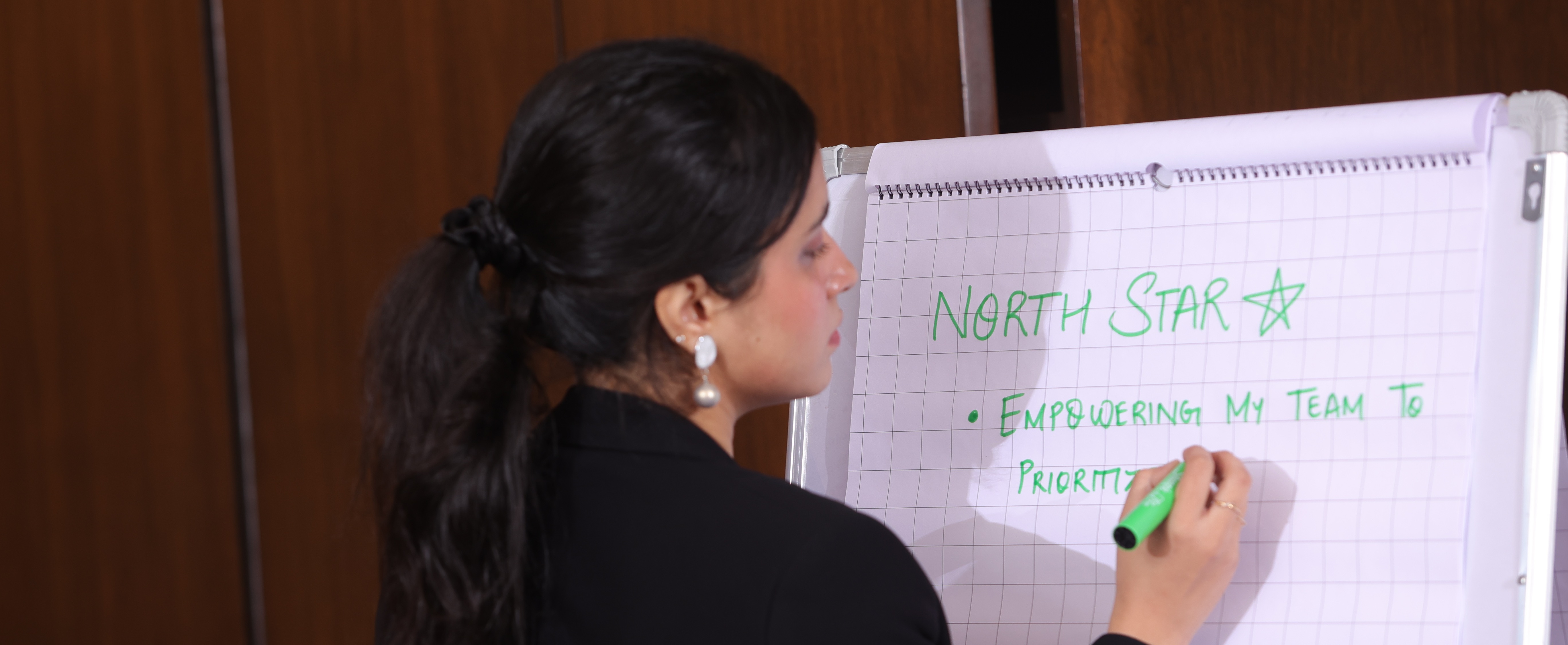Partner writing North Star priorities on flipchart